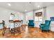 Cozy dining area with tile floors, a round table and plush turquoise accent chairs at 1451 E Brown Rd, Mesa, AZ 85203