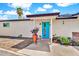 Inviting front entrance featuring a bright turquoise door and charming potted plants at 1451 E Brown Rd, Mesa, AZ 85203
