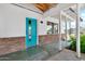 Charming front porch with a vibrant blue door and brick accents, creating a welcoming entrance at 1451 E Brown Rd, Mesa, AZ 85203