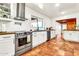 Bright kitchen showcasing stainless steel appliances, butcher block countertops, and tiled flooring throughout at 1451 E Brown Rd, Mesa, AZ 85203