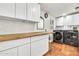 Laundry room with front loading washer and dryer and butcher block countertop at 1451 E Brown Rd, Mesa, AZ 85203