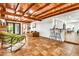 Spacious living area with exposed wood beams, opening up to a bar and dining area at 1451 E Brown Rd, Mesa, AZ 85203