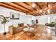 Warm living room with wooden beam ceiling, tile floors, and comfortable seating at 1451 E Brown Rd, Mesa, AZ 85203