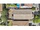 A birds eye view of a backyard with a fire pit, patio, green grass, and desert landscaping at 14793 W Surrey Dr, Surprise, AZ 85379
