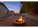 Relaxing backyard featuring a cozy fire pit, providing an inviting outdoor living space for gatherings at 14793 W Surrey Dr, Surprise, AZ 85379