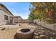 Backyard featuring a fire pit, covered patio, and low-maintenance landscaping at 14793 W Surrey Dr, Surprise, AZ 85379