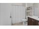 Bathroom with neutral tile floors, a shower with curtain, and storage shelves at 14793 W Surrey Dr, Surprise, AZ 85379