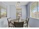 Charming dining area with a wooden table set near sunlit windows at 14793 W Surrey Dr, Surprise, AZ 85379