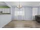 Bright dining area with stylish chandelier and large windows offering natural light, adjacent to the kitchen at 14793 W Surrey Dr, Surprise, AZ 85379