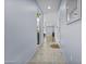 Neutral hallway featuring a tile floor and open sightlines into a living space at 14793 W Surrey Dr, Surprise, AZ 85379
