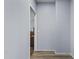 Hallway with wood flooring, neutral paint, and an open doorway to the kitchen area at 14793 W Surrey Dr, Surprise, AZ 85379