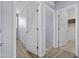 Hallway shows wood floors, neutral paint, and access to bright bedrooms and bathrooms at 14793 W Surrey Dr, Surprise, AZ 85379