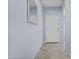 Light-filled hallway with tile flooring leading to various parts of the home at 14793 W Surrey Dr, Surprise, AZ 85379