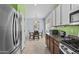 The open kitchen features stainless appliances, granite counters, and a view into the adjacent dining area at 14793 W Surrey Dr, Surprise, AZ 85379