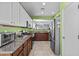 Bright kitchen features granite countertops, stainless steel appliances, and a convenient pass-through to the dining area at 14793 W Surrey Dr, Surprise, AZ 85379