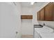 Functional laundry room with washer, dryer, and storage cabinets at 14793 W Surrey Dr, Surprise, AZ 85379