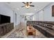 Spacious living room provides ample seating, a media cabinet, and seamless flow into the adjacent dining and kitchen areas at 14793 W Surrey Dr, Surprise, AZ 85379