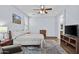 Main bedroom featuring hardwood floors, ceiling fan, and a sitting area at 14793 W Surrey Dr, Surprise, AZ 85379
