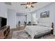 Main bedroom showcases hardwood floors, a ceiling fan, sitting area, and open flex space at 14793 W Surrey Dr, Surprise, AZ 85379