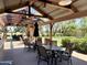 Covered outdoor seating with dining tables offering beautiful views of the surrounding landscape at 14793 W Surrey Dr, Surprise, AZ 85379