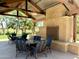Covered seating area featuring comfortable dining sets and a rustic stone fireplace at 14793 W Surrey Dr, Surprise, AZ 85379