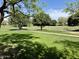 Expansive community park with walking paths and mature shade trees at 14793 W Surrey Dr, Surprise, AZ 85379
