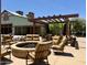 Relaxing patio with a stone fire pit and cushioned seating, perfect for outdoor gatherings at 14793 W Surrey Dr, Surprise, AZ 85379