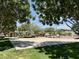 Community playground with a variety of climbing structures, swings, and slides under shady trees at 14793 W Surrey Dr, Surprise, AZ 85379