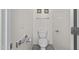 Neutral-toned toilet room featuring a toilet and grab bars at 14793 W Surrey Dr, Surprise, AZ 85379