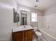 Well-lit bathroom featuring a vanity with a large mirror and a shower-tub combo at 15025 W Bottle Tree Ave, Surprise, AZ 85374