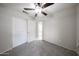 Bedroom featuring neutral carpet, white walls, ceiling fan, and closet at 15025 W Bottle Tree Ave, Surprise, AZ 85374