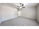 Spacious bedroom featuring neutral gray carpet and a ceiling fan for added comfort at 15025 W Bottle Tree Ave, Surprise, AZ 85374