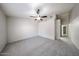 Spacious bedroom featuring neutral gray carpet and a ceiling fan for added comfort at 15025 W Bottle Tree Ave, Surprise, AZ 85374