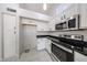 Kitchen with stainless steel oven and microwave and white cabinets with black pulls at 15025 W Bottle Tree Ave, Surprise, AZ 85374