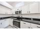 Kitchen with stainless steel oven and microwave and white cabinets with black pulls at 15025 W Bottle Tree Ave, Surprise, AZ 85374