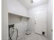 Functional laundry room with shelving and exterior access at 15025 W Bottle Tree Ave, Surprise, AZ 85374