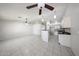 Open-concept living room and kitchen with tile flooring and ceiling fans at 15025 W Bottle Tree Ave, Surprise, AZ 85374
