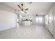 Open-concept living room and kitchen with tile flooring and ceiling fans at 15025 W Bottle Tree Ave, Surprise, AZ 85374