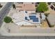 Aerial view of the home features solar panels, desert landscaping, an enclosed patio, and a storage shed at 1563 E Racine Dr, Casa Grande, AZ 85122