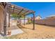 Backyard featuring a shaded patio, shed, and low-maintenance landscaping at 1563 E Racine Dr, Casa Grande, AZ 85122