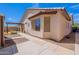 Exterior shot of the backyard featuring desert landscaping, a covered patio, and an attached sunroom at 1563 E Racine Dr, Casa Grande, AZ 85122