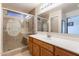 Bathroom with glass-enclosed shower featuring unique etched glass and a built-in bench at 1563 E Racine Dr, Casa Grande, AZ 85122