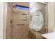 Tiled walk-in shower with built-in bench and grab bars for safety and relaxation at 1563 E Racine Dr, Casa Grande, AZ 85122