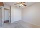A carpeted bedroom features a ceiling fan and a closet with sliding doors, maximizing space and storage at 1563 E Racine Dr, Casa Grande, AZ 85122