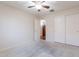 An inviting carpeted bedroom features a ceiling fan and a sliding-door closet for ample storage at 1563 E Racine Dr, Casa Grande, AZ 85122