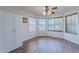 Bright dining area with wood-look floors, a ceiling fan, and large windows at 1563 E Racine Dr, Casa Grande, AZ 85122