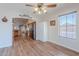 Bright dining area offers wood-look flooring, a ceiling fan, and views into the kitchen at 1563 E Racine Dr, Casa Grande, AZ 85122