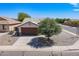Charming single-story home with desert landscaping, a private driveway, and mature shade tree at 1563 E Racine Dr, Casa Grande, AZ 85122