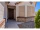 Inviting front porch with security door, stone accents, and easy care desert landscaping at 1563 E Racine Dr, Casa Grande, AZ 85122