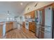 Charming kitchen features oak cabinetry, stainless appliances, and wood-look flooring at 1563 E Racine Dr, Casa Grande, AZ 85122